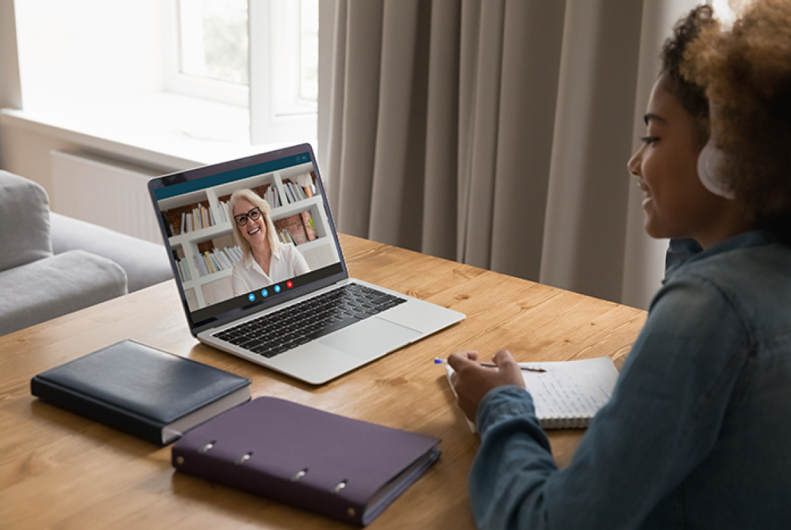 student on laptop having telehealth visit